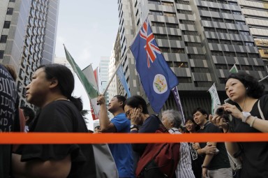 Protesters raise a Hong Kong colonial flag as thousands of people rally earlier this month against the latest NPC interpretation of the Basic Law. Photo: AP Protesters raise a Hong Kong colonial flag as thousands of people rally earlier this month against the latest NPC interpretation of the Basic Law. Photo: AP
