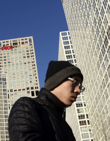 A Chinese man walks in the central business district in Beijing. Standard & Poor’s has cut China’s sovereign credit outlook. Photo: AFP