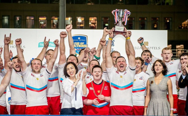 Russia captain Vasily Artemyev is surrounded by his team as he lifts the Cup of Nations for a second straight year after his side’s 27-0 win over Hong Kong at Hong Kong Football Club on Saturday evening. Photos: SCMP Pictures