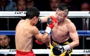 (160130) -- SHANGHAI , Jan. 30, 2016 (Xinhua) -- Zou Shiming (R) of China fights against Natan Coutinho of Brazil in their WBO international flyweight boxing title bout in Shanghai, east China, Jan. 30, 2016.(Xinhua/Fan Jun)(wll)