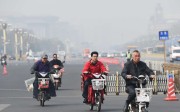 Residents ride electric bikes on Changan Avenue in Beijing. Changan Avenue is one of 10 roads in the city where electric bicycles will be banned starting from April 11. Photo: Xinhua