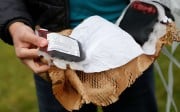A Zipline employee displays a package of fake blood airdropped by one of its drones during a flight demonstration in the San Francisco Bay Area, California. This summer, the company will start delivering blood to hospitals and health centres in Rwanda. Photo: Reuters