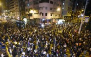 People take to the streets of Hong Kong on November 6, to protest Beijing's attempts to stop a fledgling independence movement. Police officers who formed a barricade to stop their advance resorted to using pepper spray on the protestors. Photo: KYODO