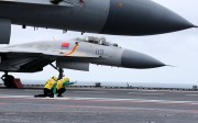 A J-15 jet fighter prepares to take off from the deck of the Liaoning, China's first aircraft carrier, during a drill in the South China Sea on Monday. Photo: CNS
