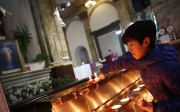 A file picture of a boy lighting candles at a state-approved Catholic church in Beijing. Photo: EPA
