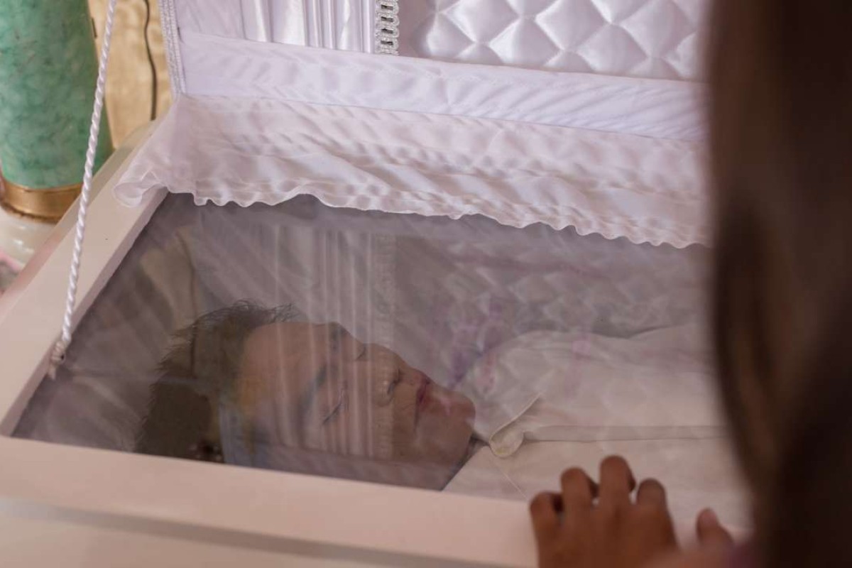 Angelica stands by her father Agustine da Silva’s casket at his wake, in Tugatog, in Manila’s Malabon City. Picture: Paul Ratje