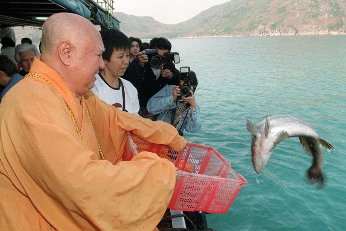 Reverend Sik Wing-sing releases a fish off Sai Kung in a “saving life” ritual in 1997. The practice is widespread in the city. Picture: Robert Ng