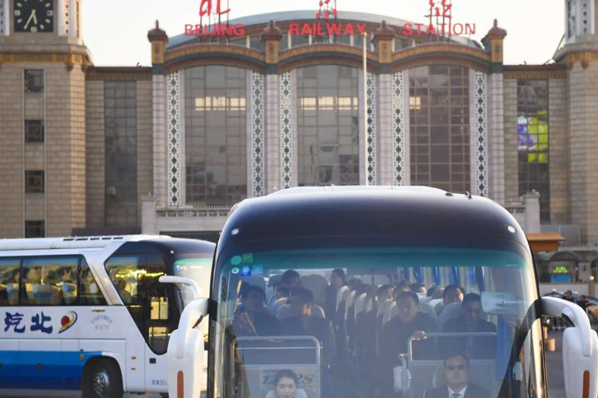Deputies to the 12th National People's Congress from northeast China's Liaoning Province head for their accommodation by bus after arriving at Beijing Railway Station in Beijing. Photo: Xinhua