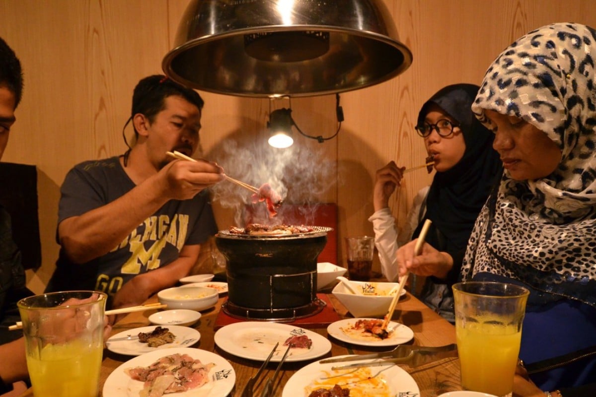Thai Muslim tourists enjoy halal certified food at a barbecue restaurant in Tokyo. Image: AFP