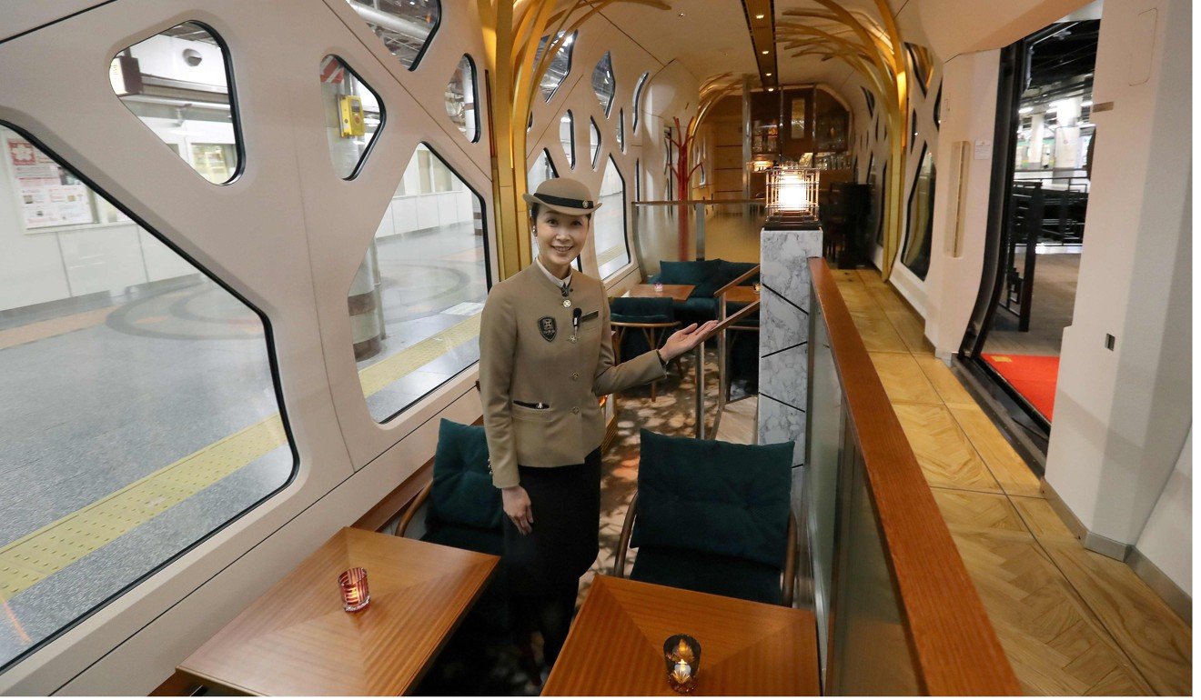 A crew member in the lounge car of the Train Suite Shiki-Shima. The luxury sleeper Shiki-Shima, which can accommodate up to 34 passengers, has 10 cars, including a lounge car, a dining car and two observatory cars. Photo: AFP