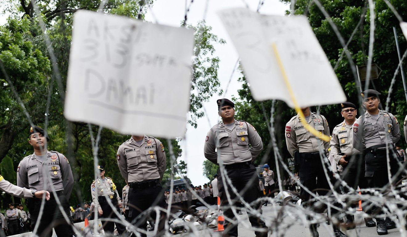 Police block a road during a protest by Indonesian Muslims to demand Jakarta’s Christian governor be jailed for blaspheming Islam. Photo: AFP
