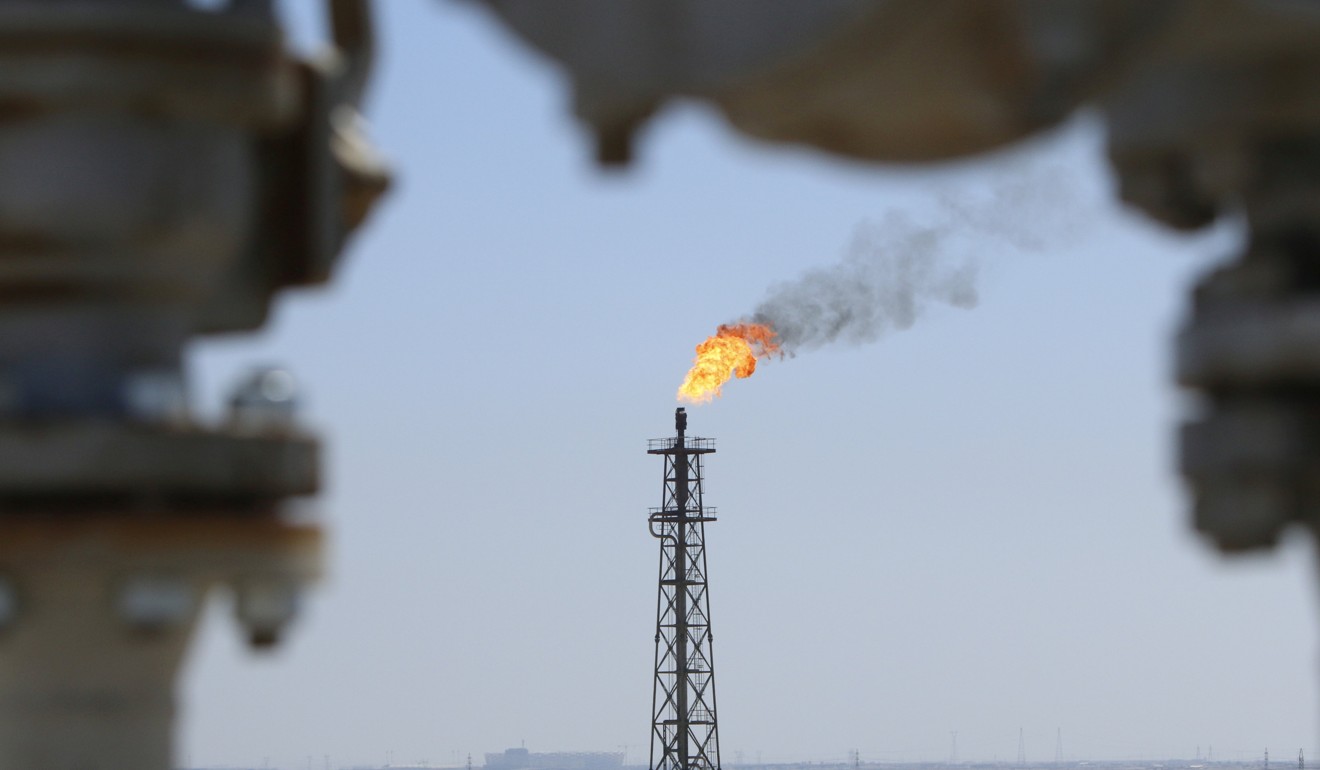 Gas burns off at the al-Shuaiba oil refinery near Basra, Iraq, as OPEC mulls extending oil output cuts to mop up a surplus in the market. Photo: Reuters