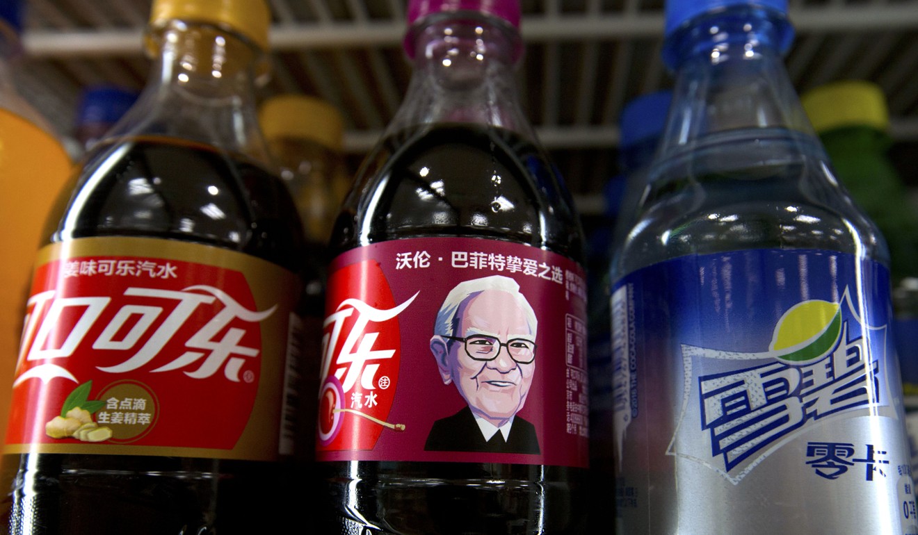 A bottle of Cherry Coca-Cola with a portrait of Berkshire Hathaway Chairman and CEO Warren Buffett sits on a shelf with other soft drinks at a convenience store in Beijing. He’s being used on Coke’s new water brand too. Photo: AP