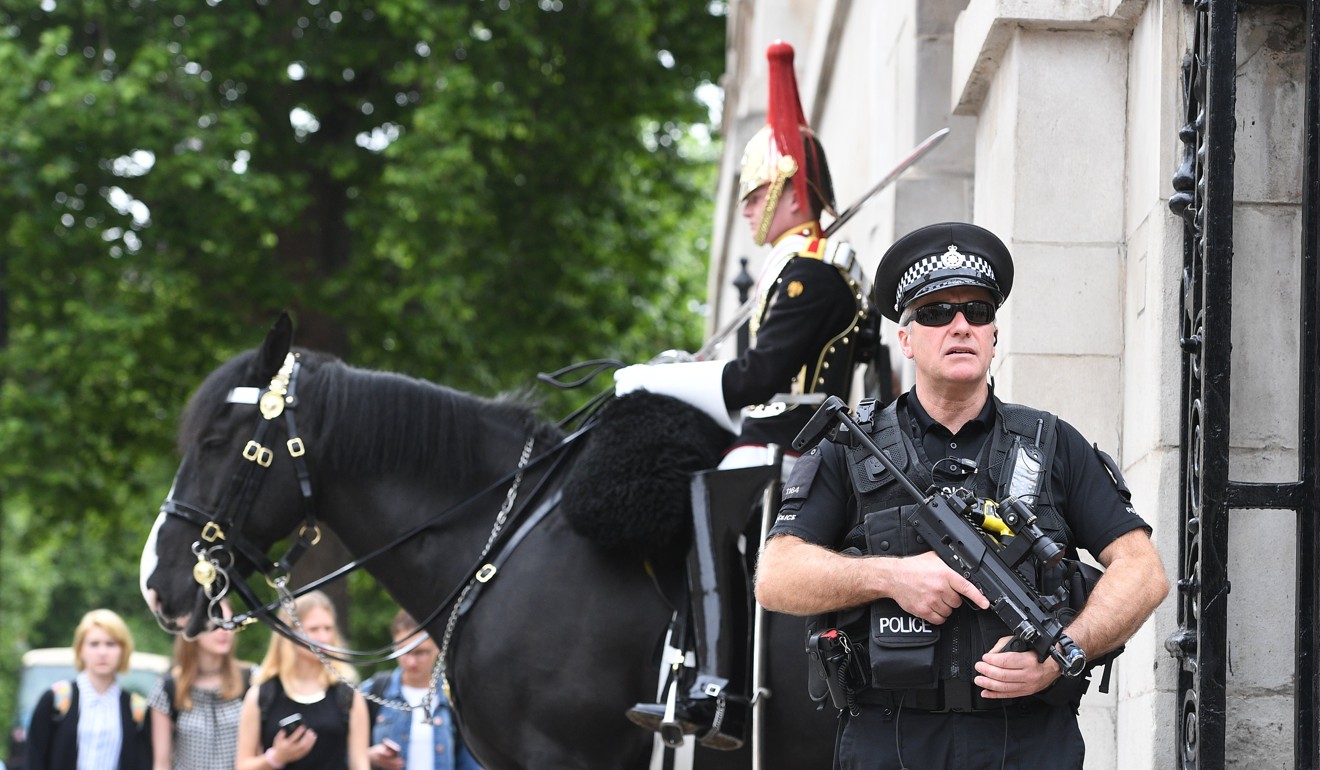 An armed police officer stands guard in London. Photo: EPA