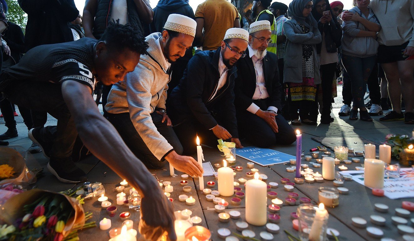 People lay tributes at a vigil for the people who lost their lives during the Manchester terror attack. Photo: EPA