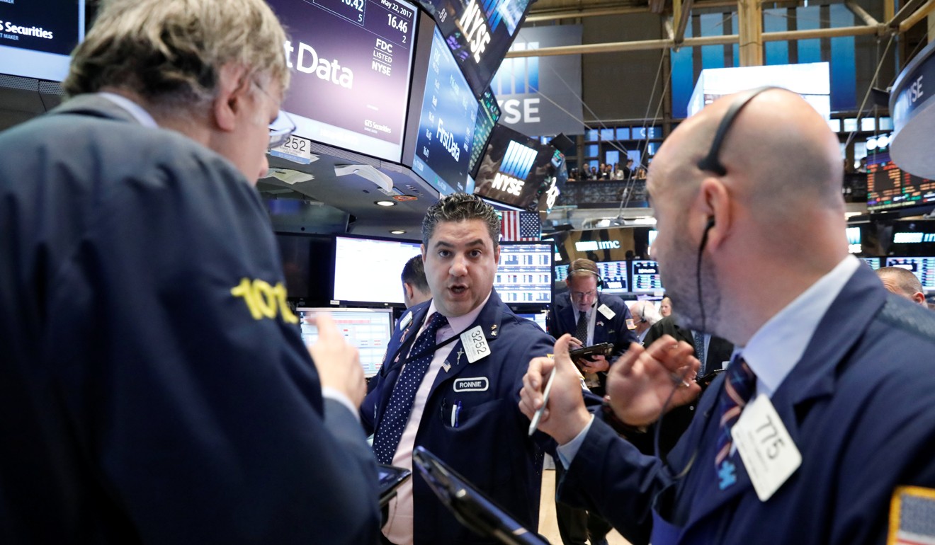 Traders discuss trading strategies on the New York Stock Exchange (NYSE). Photo: Reuters