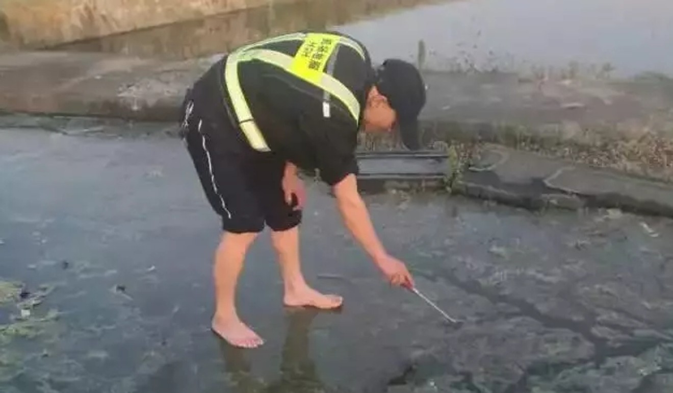 Going through the motions: Another cleaner walks barefoot through the discharged aircraft sewage in search of the lost 300,000 yuan diamond ring that was lost in the aircraft toilet. Photo: Handout
