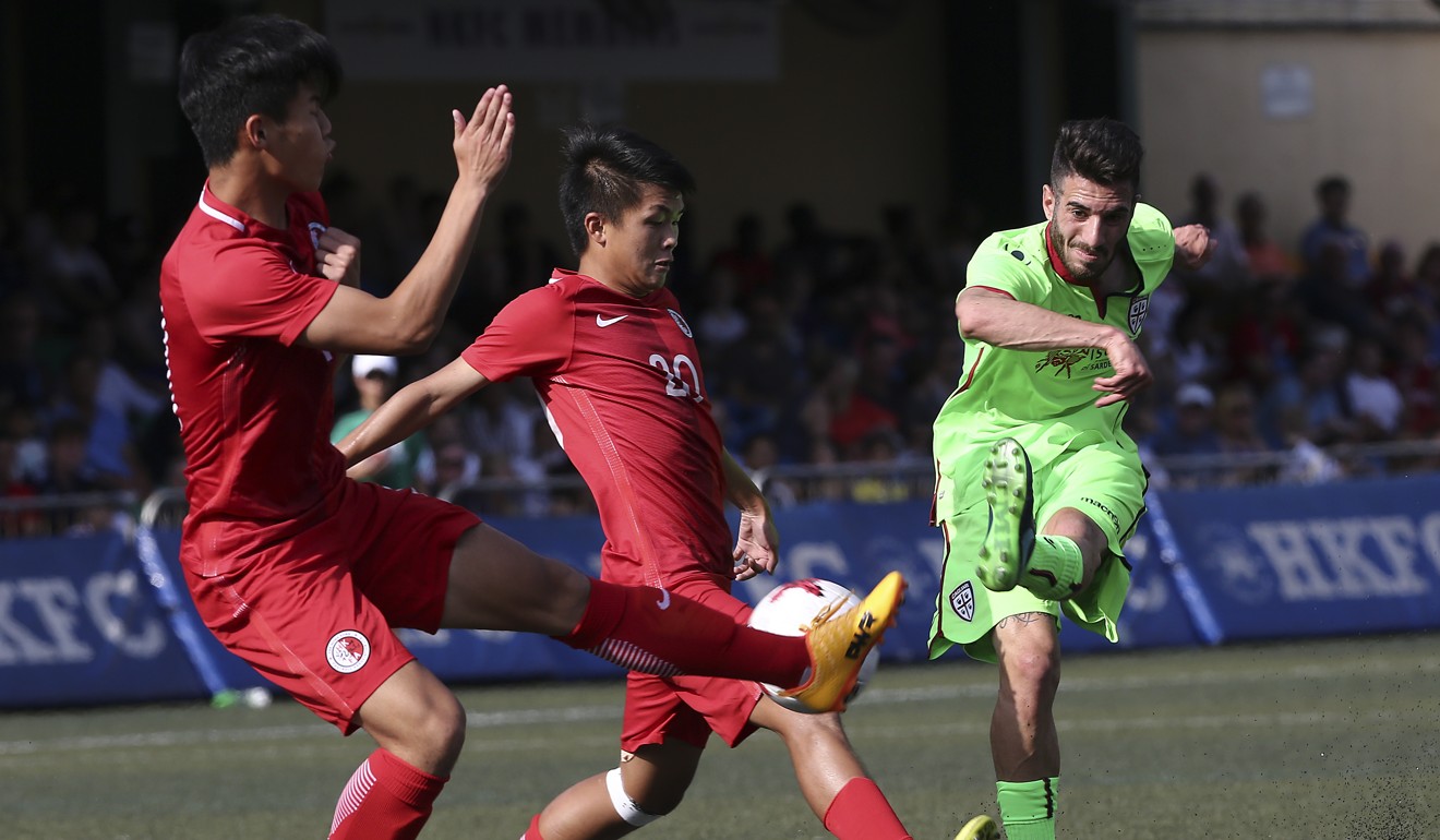 Cagliari Calcio’s Mattia Muroni (right) shoots against HKFA Red Dragons at the HKFC CITI Soccer Sevens. Photo: Jonathan Wong