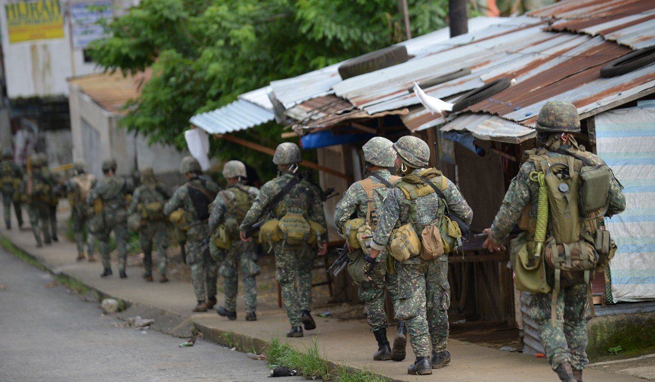 Marines walk to an assault on the hide out of Muslim militants near the town centre in Marawi. Photo: AFP