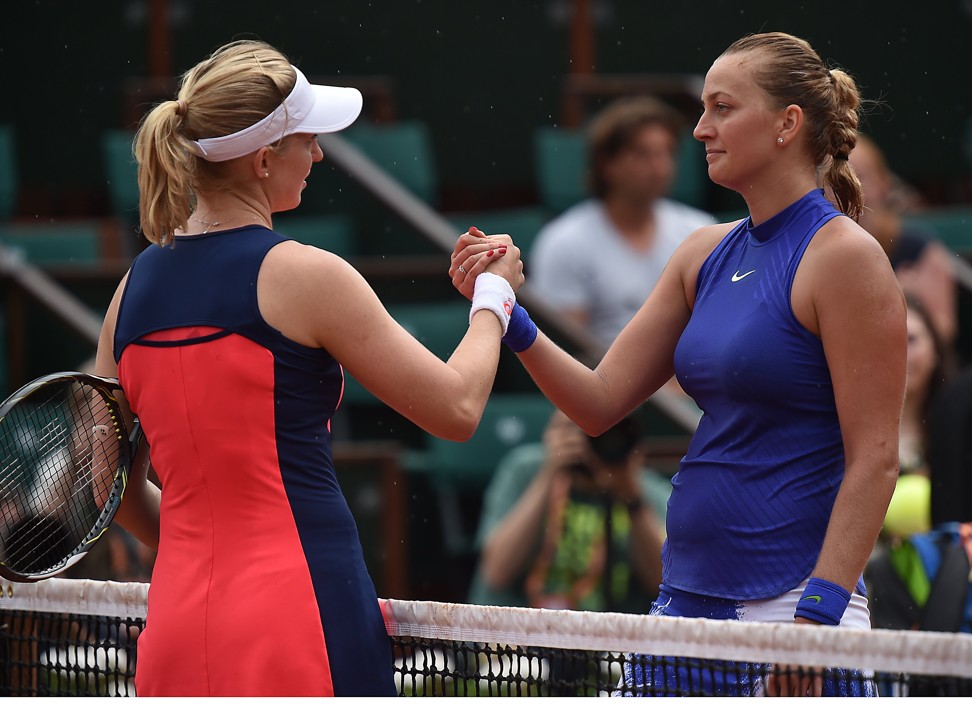 Petra Kvitova (right) shakes hands with Julia Boserup after their match. Photo: EPA