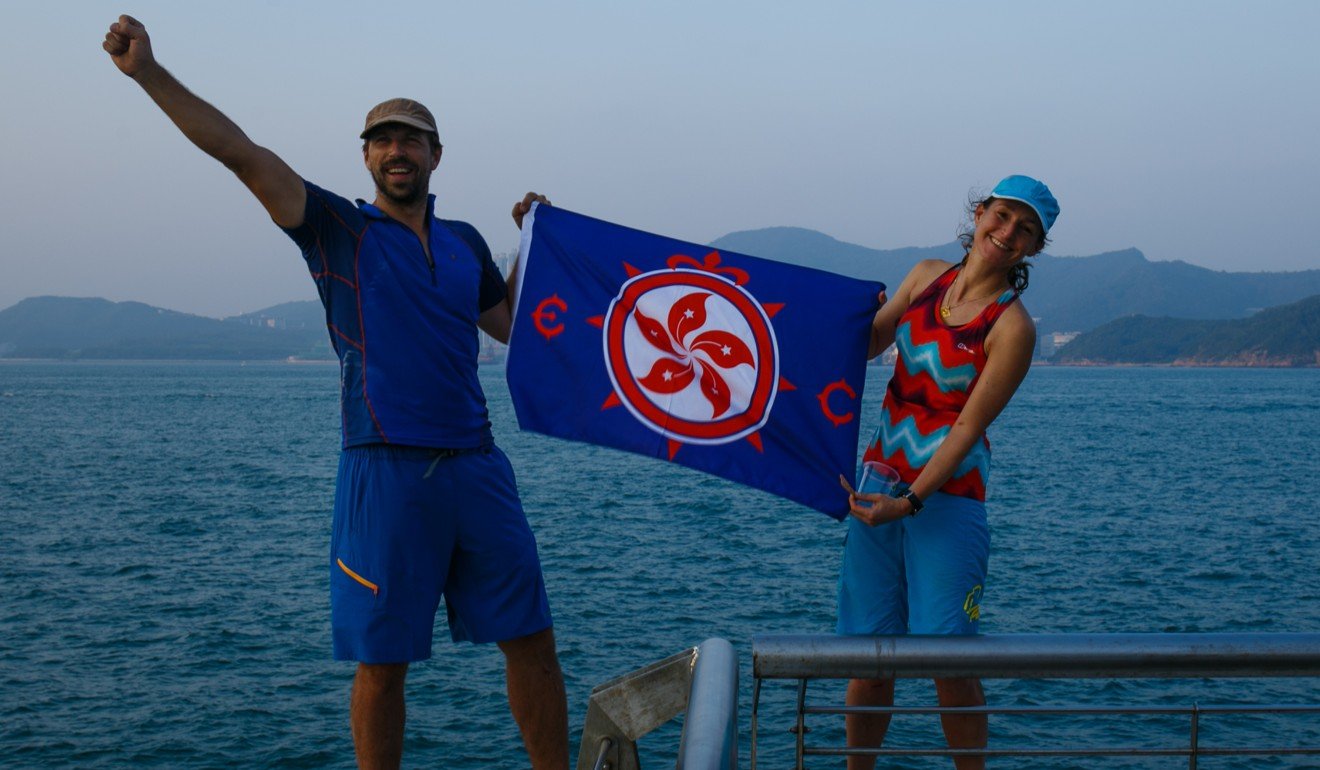Holding up the flag of the local chapter of The Explorers Club, which promotes scientific exploration and field study. Photo: Tessa Chan
