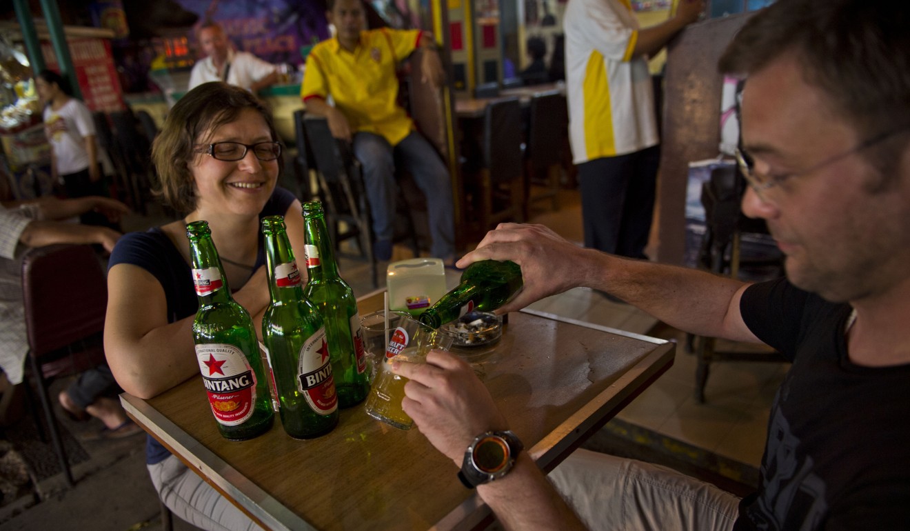 Tourists drink beer in Jakarta, where a variant of ‘don’t ask, don’t tell’ is a maxim for keeping the peace between hardline conservatives and secularists. Photo: AFP