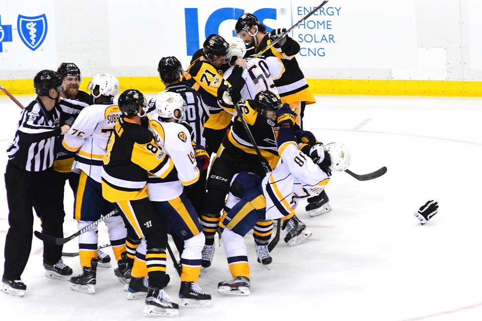 Evgeni Malkin of the Pittsburgh Penguins fights Roman Josi of the Nashville Predators as Carl Hagelin of Pittsburgh fights Viktor Arvidsson of Nashville in the third period of game five. Photo: AFP