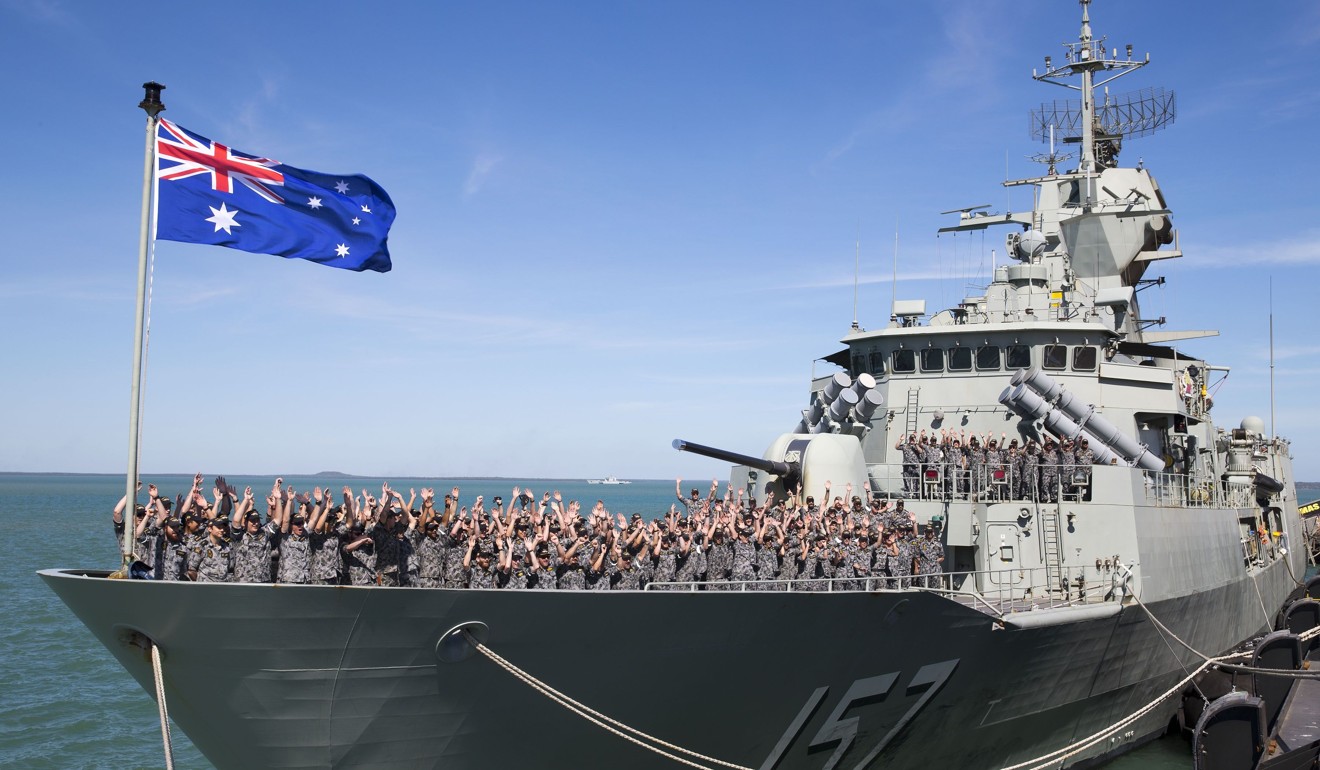 The crew of HMAS Perth, one of the Royal Australian Navy’s eight Anzac-class frigates, cheer as they arrive in the Port of Darwin. Photo: AFP