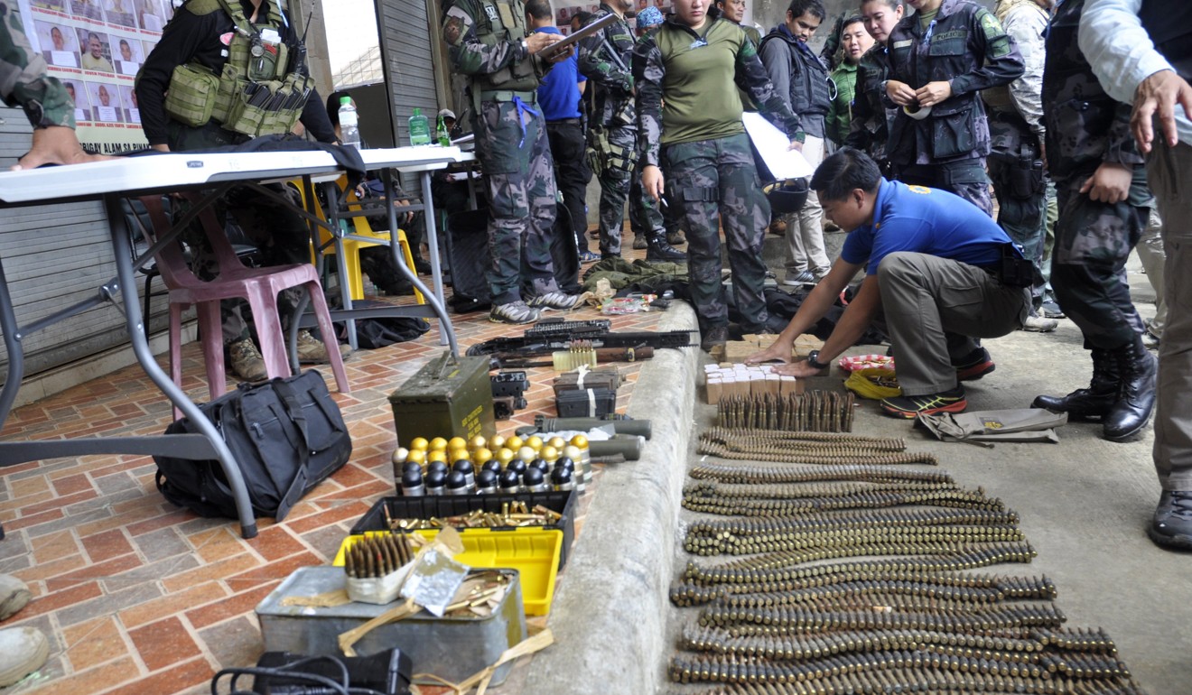 Confiscated firearms and bullets are displayed by Filipino soldiers as fighting between Islamist militants and government forces continues in Marawi. Photo: EPA