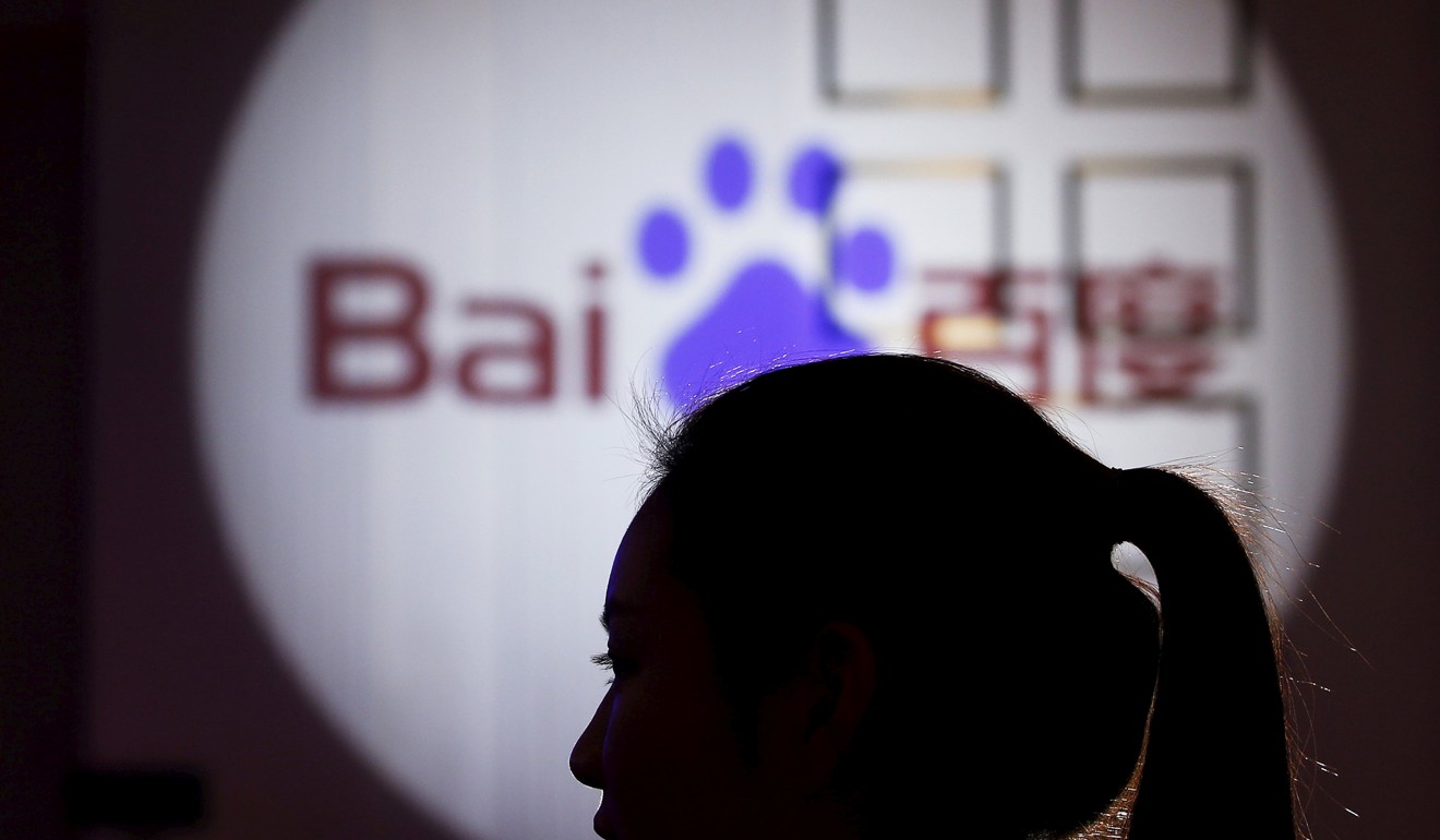 A woman is silhouetted against the Baidu logo at a new product launch from Baidu, in Shanghai. The company is setting up an AI investment in the US technology hub of Silicon Valley. Photo: Reuters