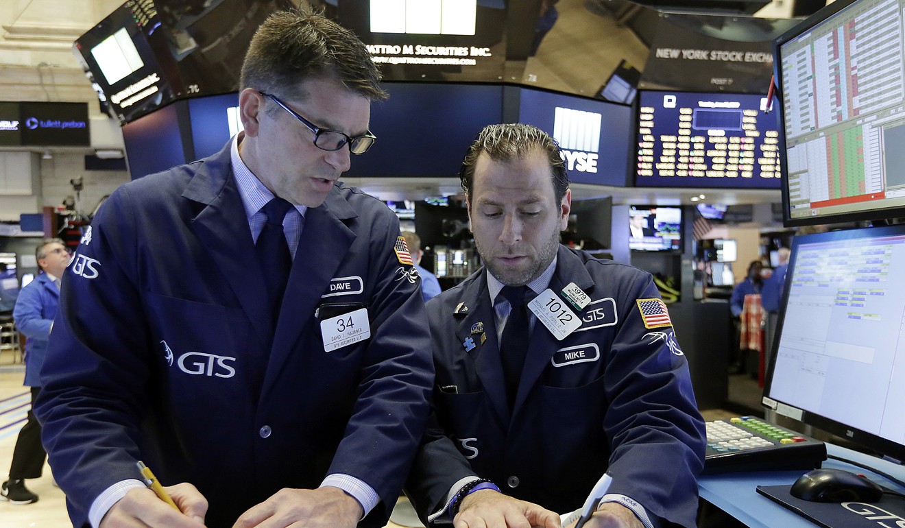 Specialists David Haubner, left, and Michael Pistillo work on the floor of the New York Stock Exchange. Technology shares rose after a two-day sell-off. Photo: AP