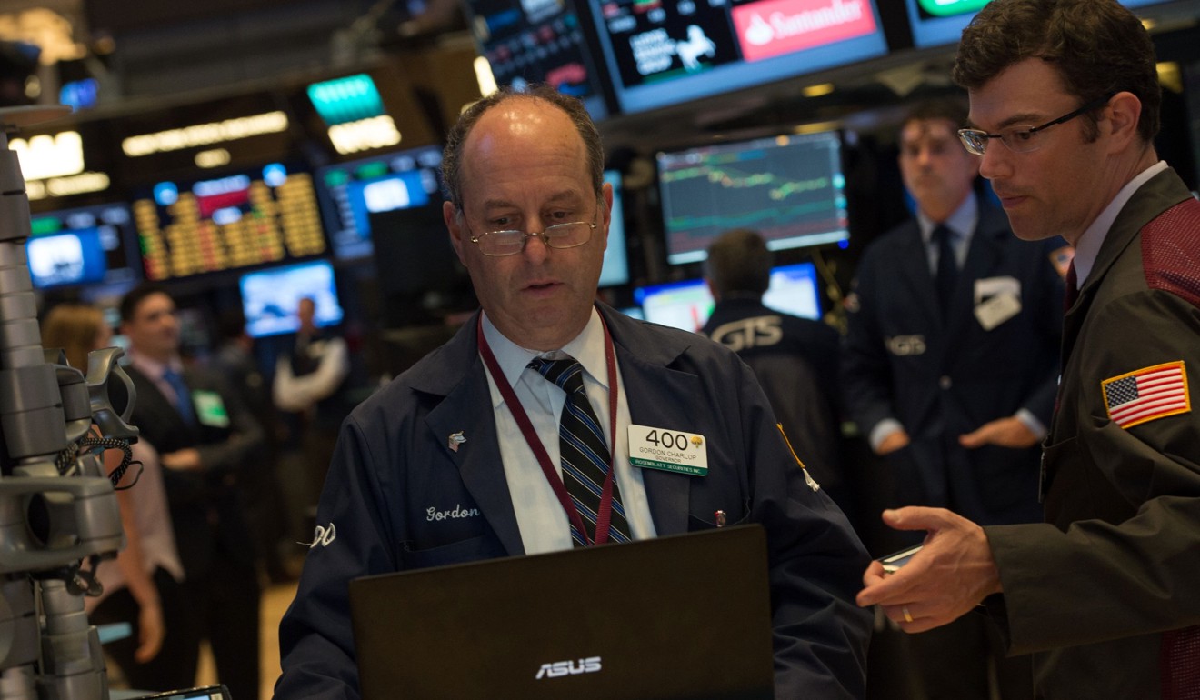 Traders compare notes during trading in New York. Photo: AFP