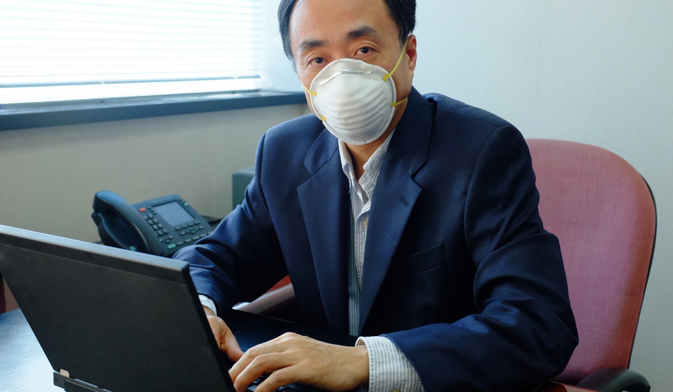 A man wears a face mask inside an office due to air pollution.