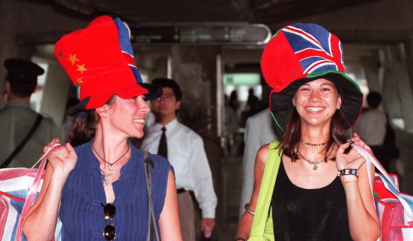 Hong Kong locals Natasha Edwards, left, and Emma Lo wear Hong Kong Handover Hats, featuring Chinese and British flags, in Central in 1997. Photo: AFP
