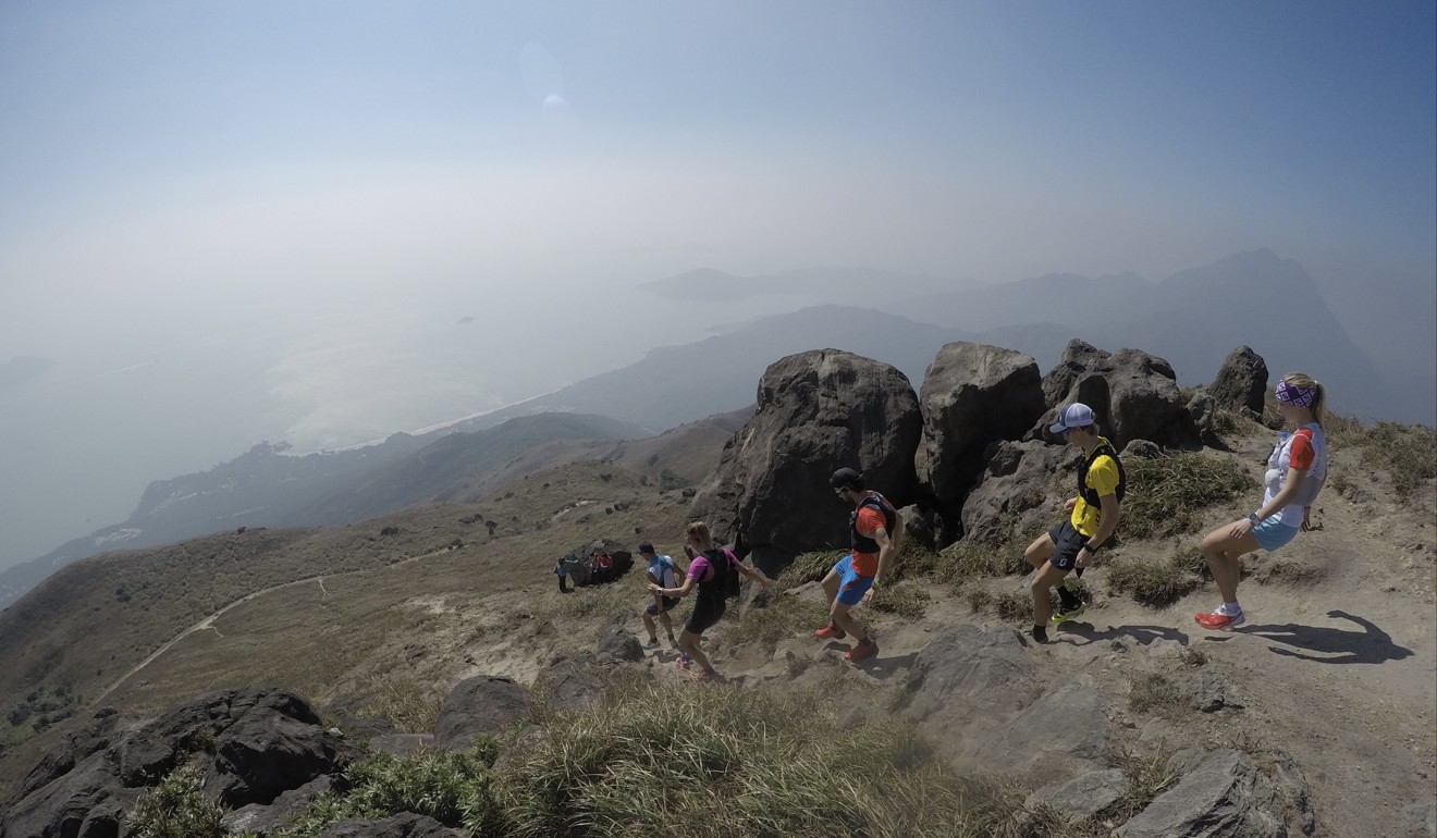 Runners training for the MSIG Lantau 50 race descend from the summit of Sunset Peak on Lantau in December 2016. Olya Korzh wants to win the MSIG 50km race series again so she can represent Hong Kong in a world championships. Photo: Jeanette Wang