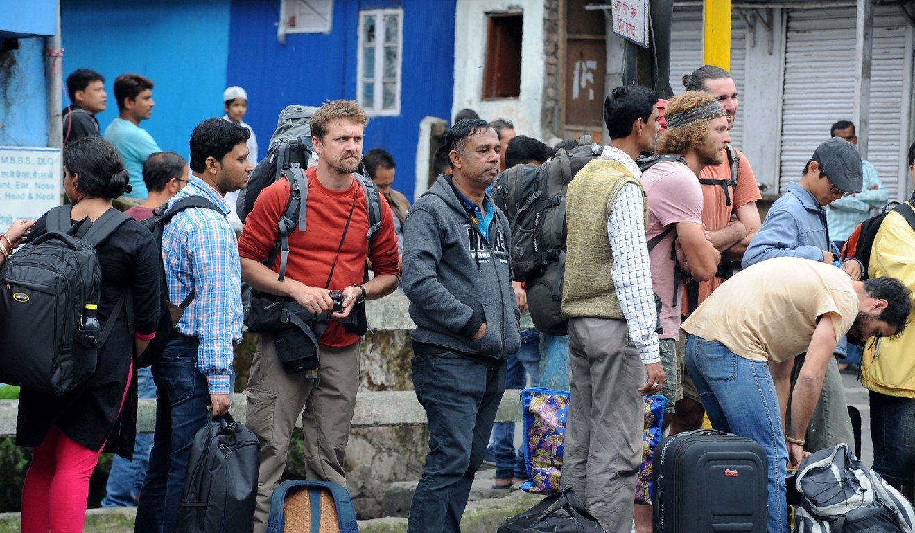 Tourists queue to leave Darjeeling amid clashes between Indian security personnel and protesters and an indefinite strike called by the Gorkha Janmukti Morcha. Photo: AFP