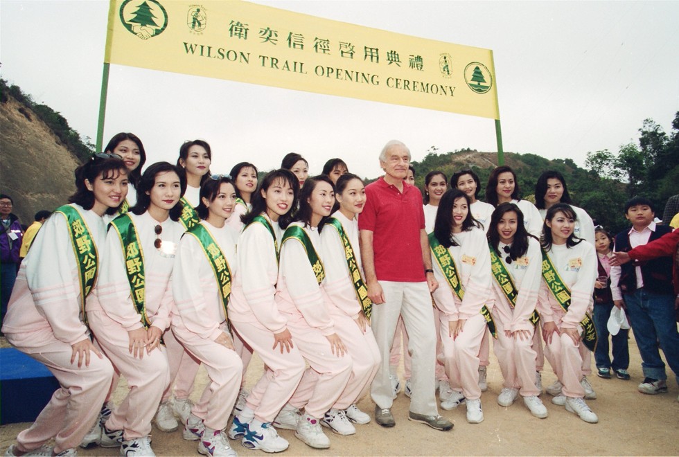 David Wilson joins contestants in the Miss Chinese International beauty pageant during the opening ceremony for the hiking trail named after him. Photo: SCMP