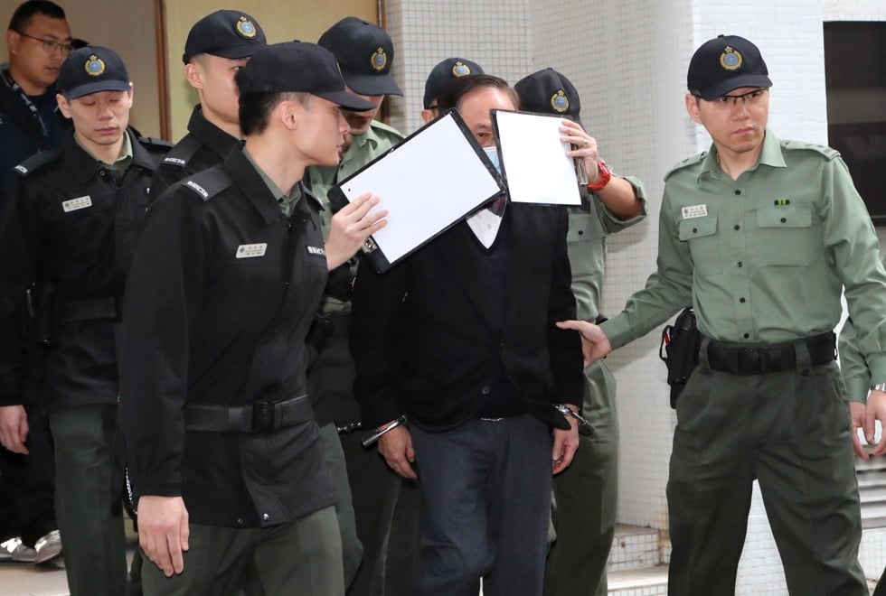 Former chief executive Donald Tsang is escorted in chains to a prison van. Photo: Edward Wong