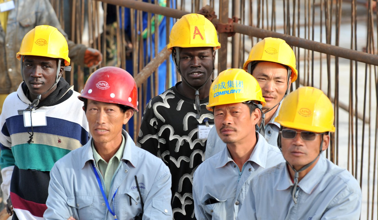 Senegalese and Chinese workers at a theatre construction site financed by China in the capital Dakar. Photo: AFP