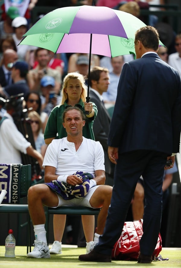 Alexandr Dolgopolov retired injured during his match with Federer, but still picked up £35,000 for making it to the court. Photo: EPA