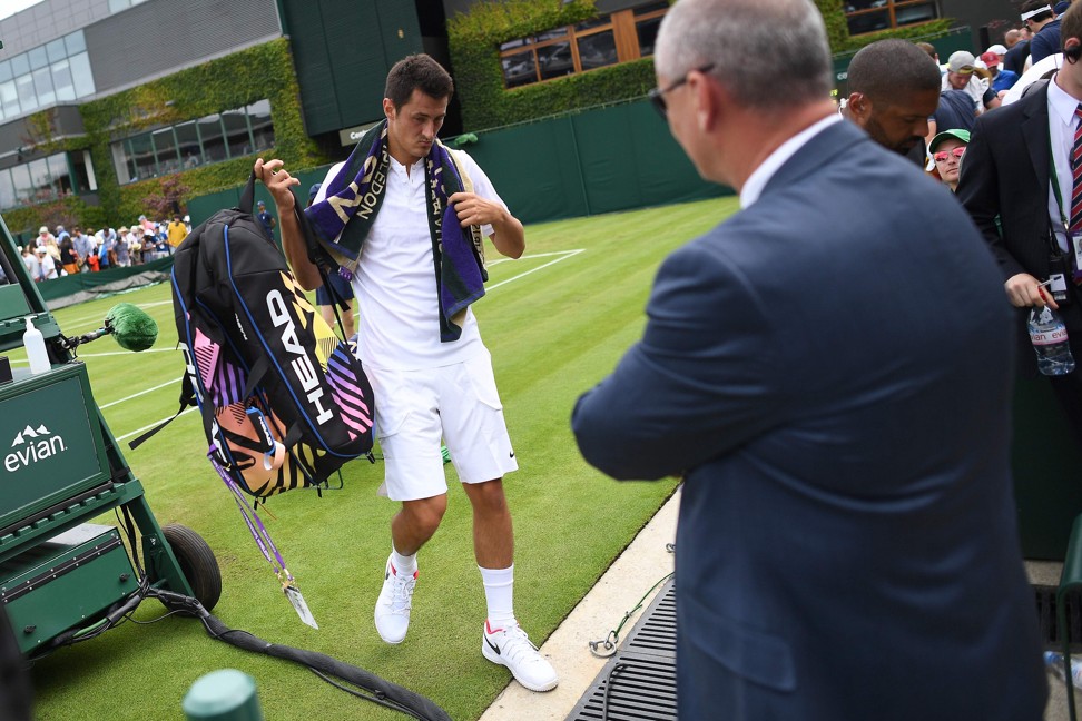 Tomic leaves the court after his straight sets loss to Zverev. Photo: AFP