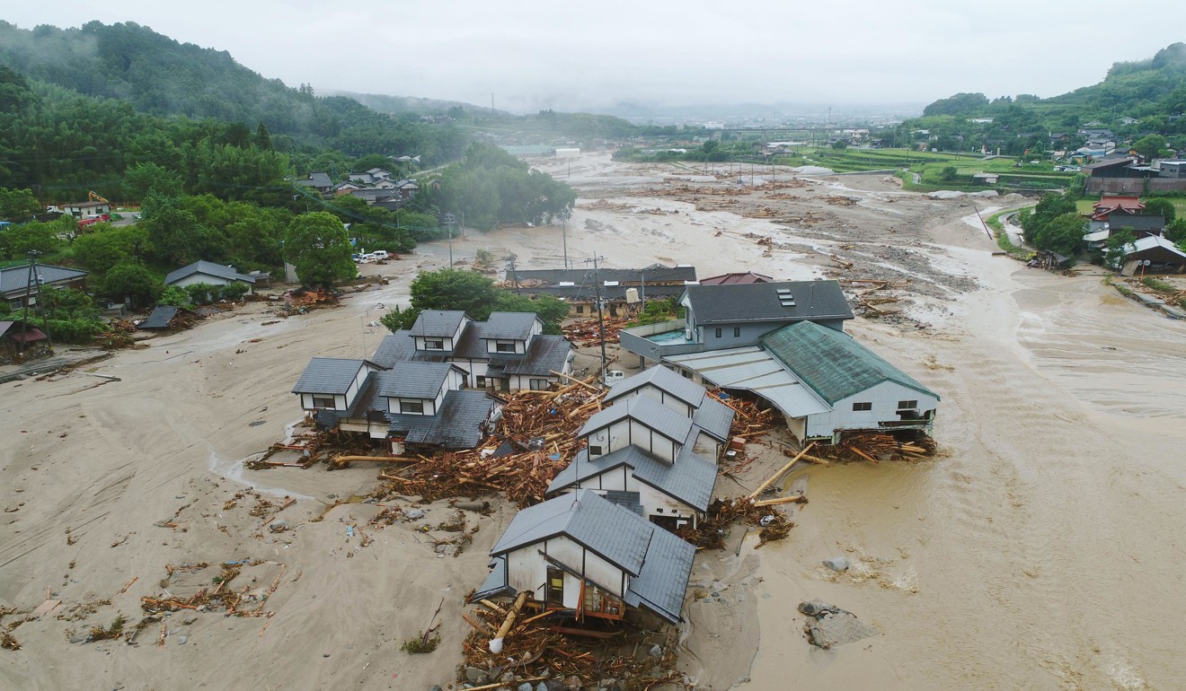 Houses are collapsed and half-buried in the mud following the flooding caused by heavy rain in Asakura. Photo: Kyodo