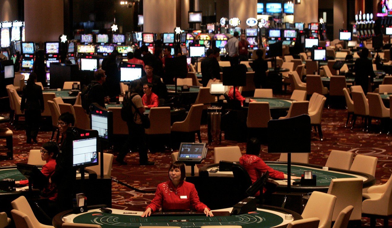 Dealers wait for customers inside Melco Crown Entertainment’s City of Dreams in Macau. Photo: Reuters