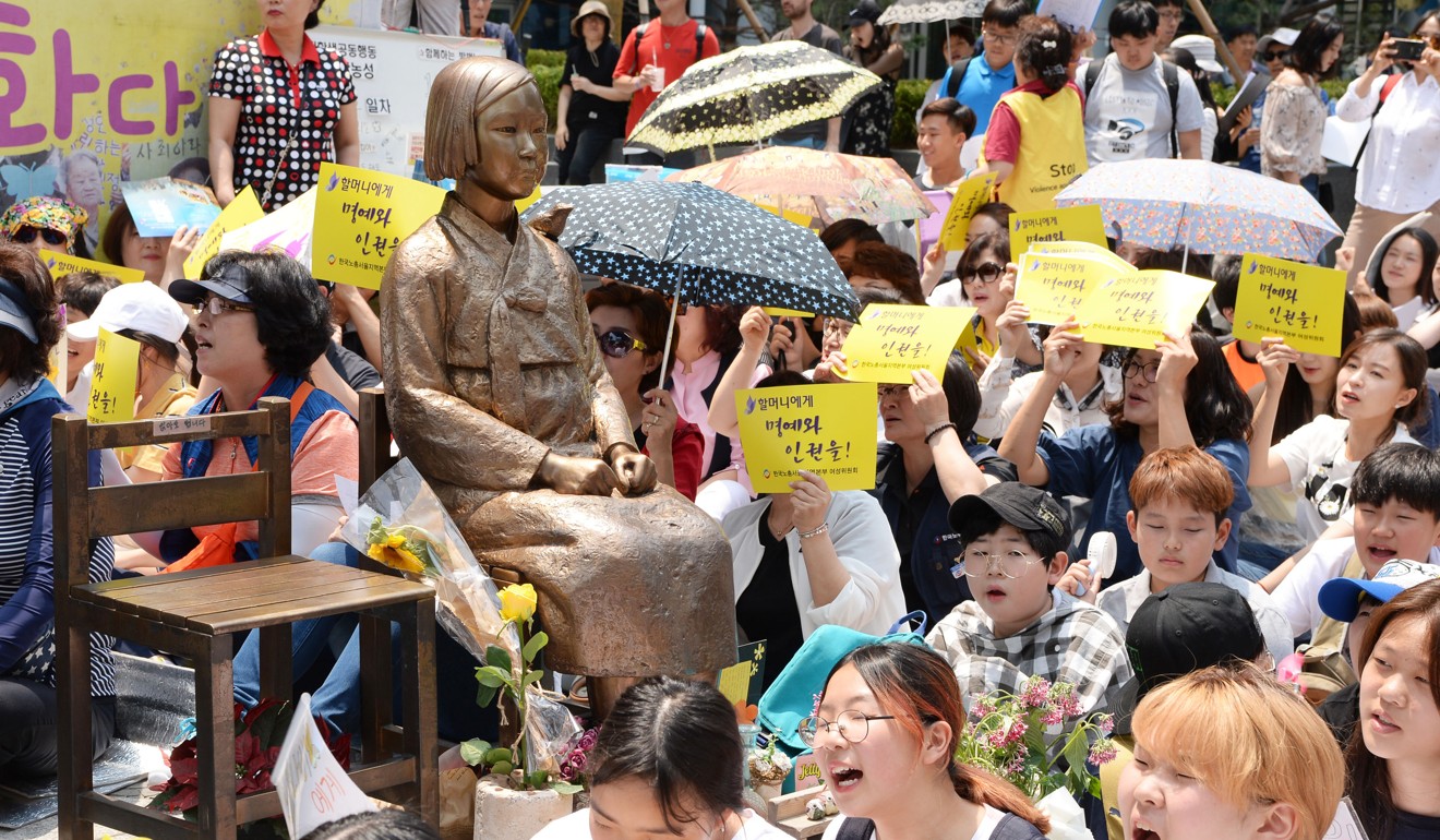 South Koreans, opposed to the 2015 agreement between Seoul and Tokyo on the issue of Korean ‘comfort women’ forced to work in wartime Japanese military brothels, rally around a bronze statue of a young girl symbolising such women near the Japanese Embassy in Seoul. Photo: Kyodo