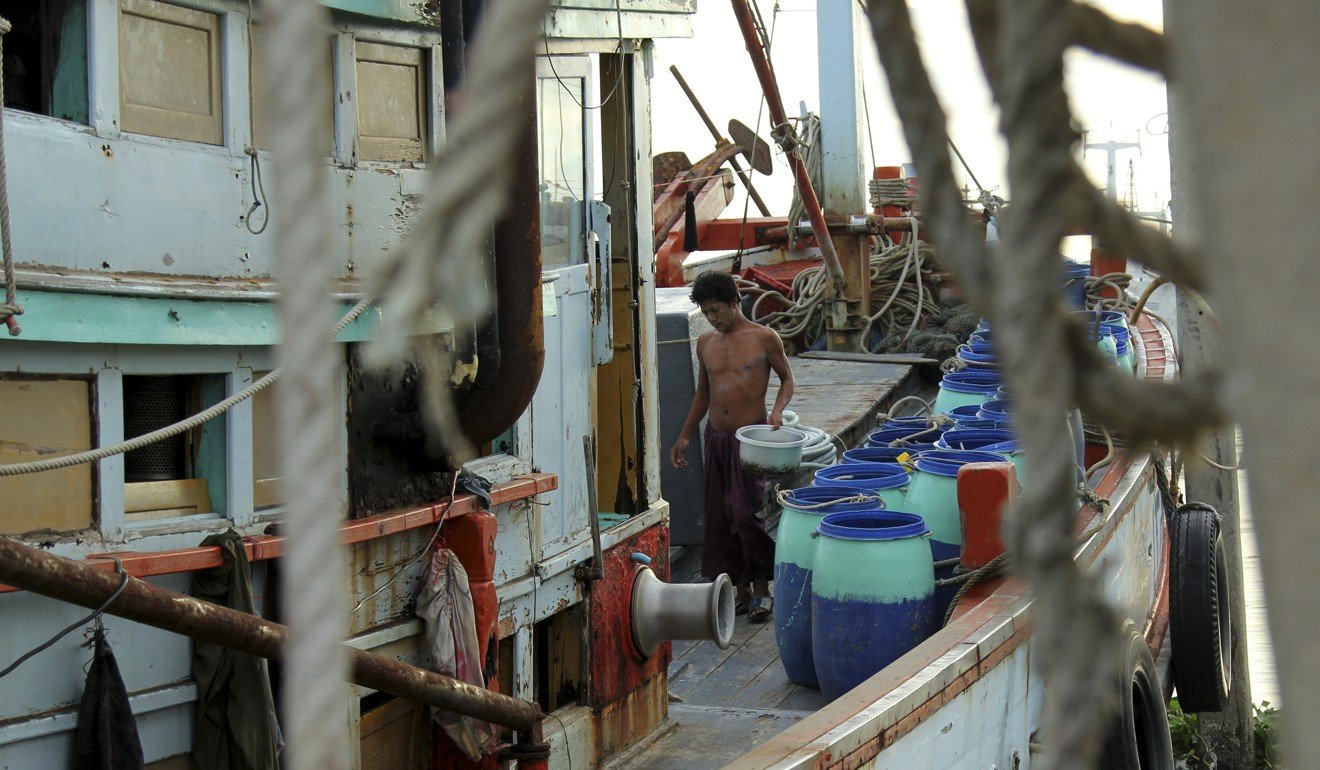 A migrant from Myanmar cleans a fishing vessel in the port of Mahachai, one of the main hubs of the Thai fishing industry. Photo: Laura Villadiego