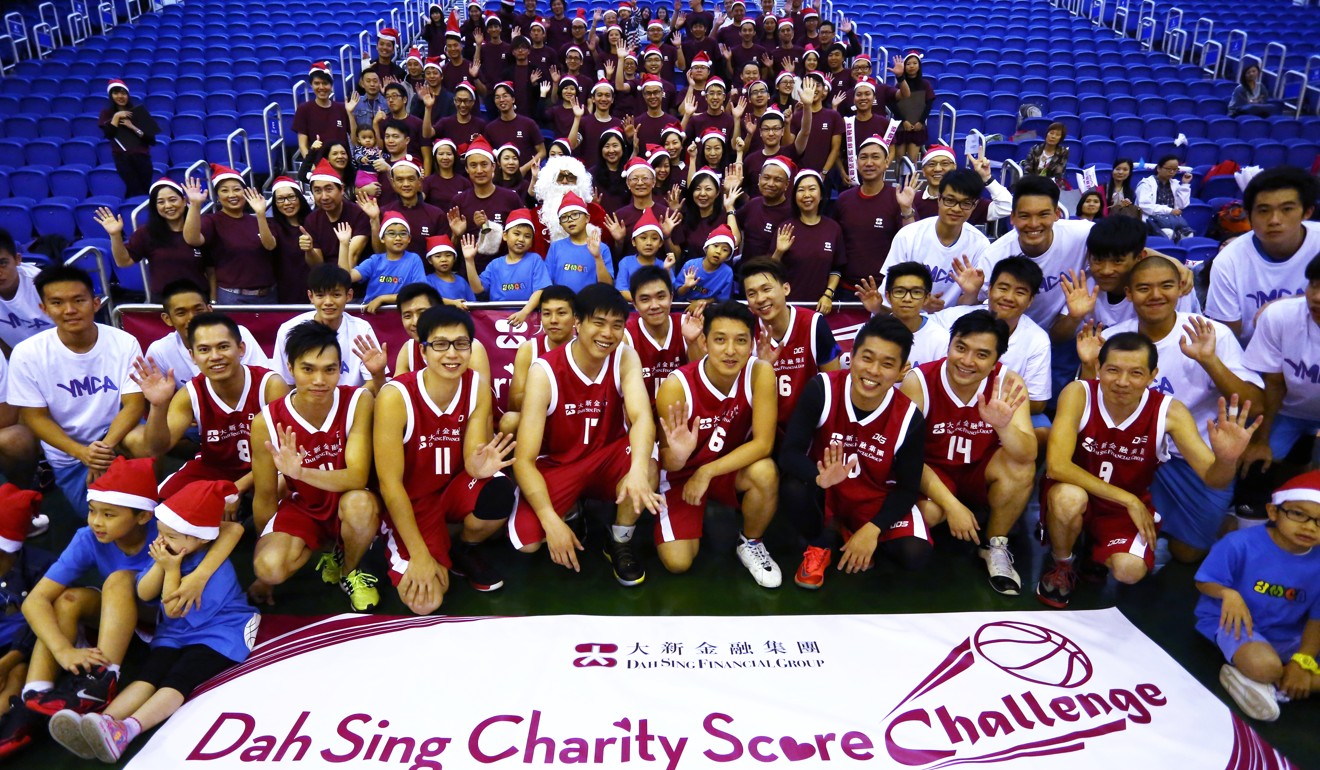 Participants pose for a group photo at the Dah Sing Charity Score Challenge basketball match in the indoor arena of the Southorn Playground in Wan Chai, on November 22, 2014. Photo: Jonathan Wong