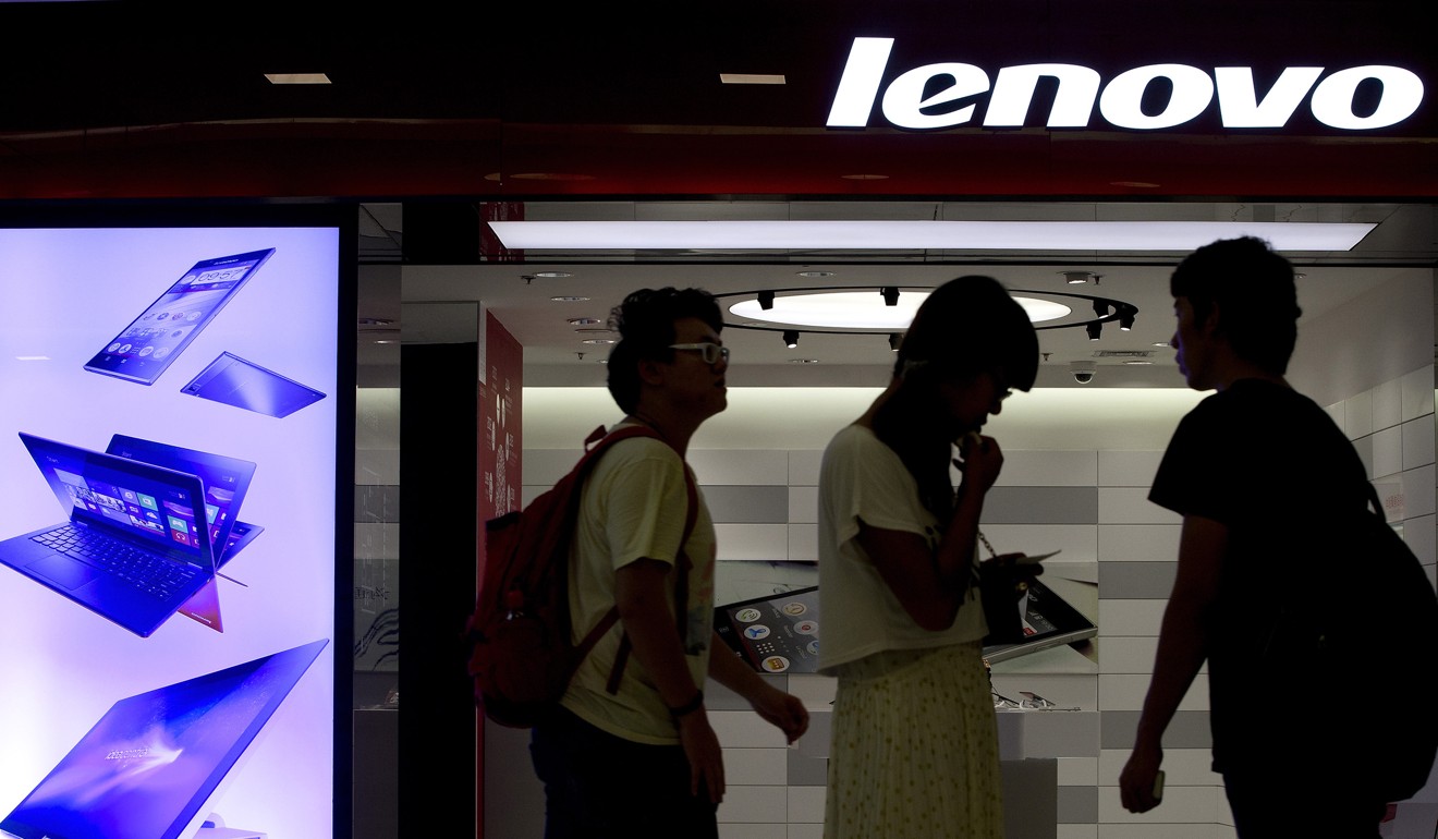 People walk past a Lenovo flagship experience store in Beijing. Photo: Andy Wong