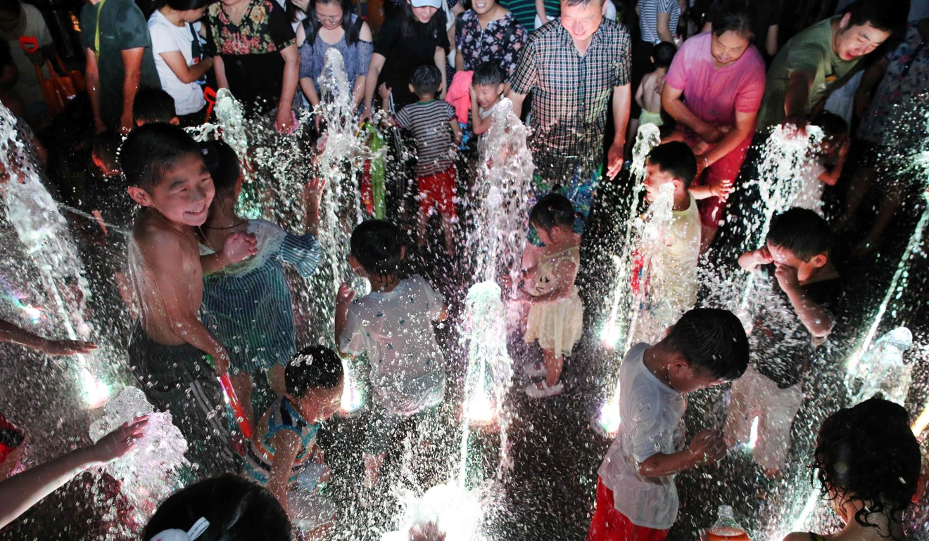 People cool off in a fountain in Yangzhou, Jiangsu province. Photo: AFP