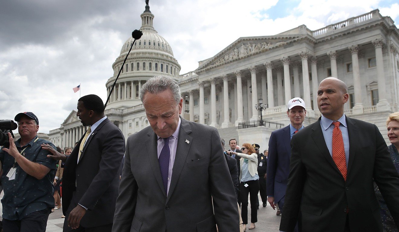 Senate Minority Leader Chuck Schumer leads Democratic members of the Senate to a press conference after Republicans successfully passed a key procedural vote in the US Senate to open debate on replacing Obamacare. Photo: AFP