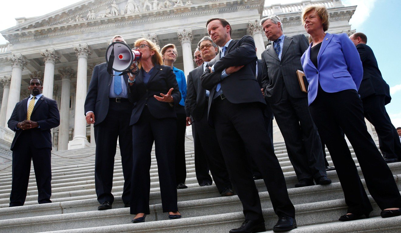 Senate Democrats gather on the Senate steps with protesters on Capitol Hill in Washington over attempts by Republicans to repeal Obamacare. Photo: Reuters